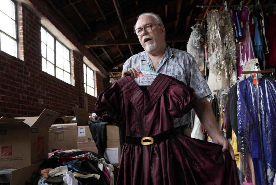 Shon LeBlanc, co-owner of costume rental service Valentino's Costume Group, displays a costume used in the musical production "Gavroche," Friday, May 26, 2023, at his warehouse in Los Angeles. (AP Photo/Chris Pizzello)