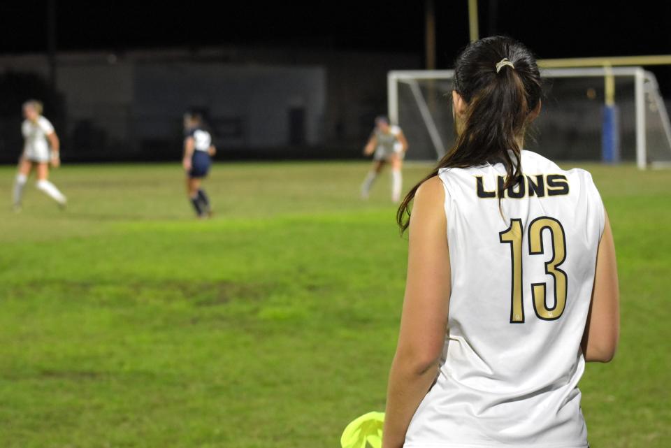 Olympic Heights' Avi Solorzano looks on as her teammates play a regular season game against Spanish River on Nov. 27, 2023.