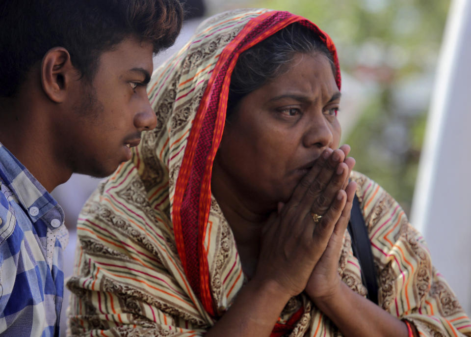 A woman reacts after identifying a body of her family member, who was killed in the Friday's plane crash, at a morgue in Karachi, Pakistan, Saturday, May 23, 2020. An aviation official says a passenger plane belonging to state-run Pakistan International Airlines carrying passengers and crew has crashed near the southern port city of Karachi. (AP Photo/Fareed Khan)
