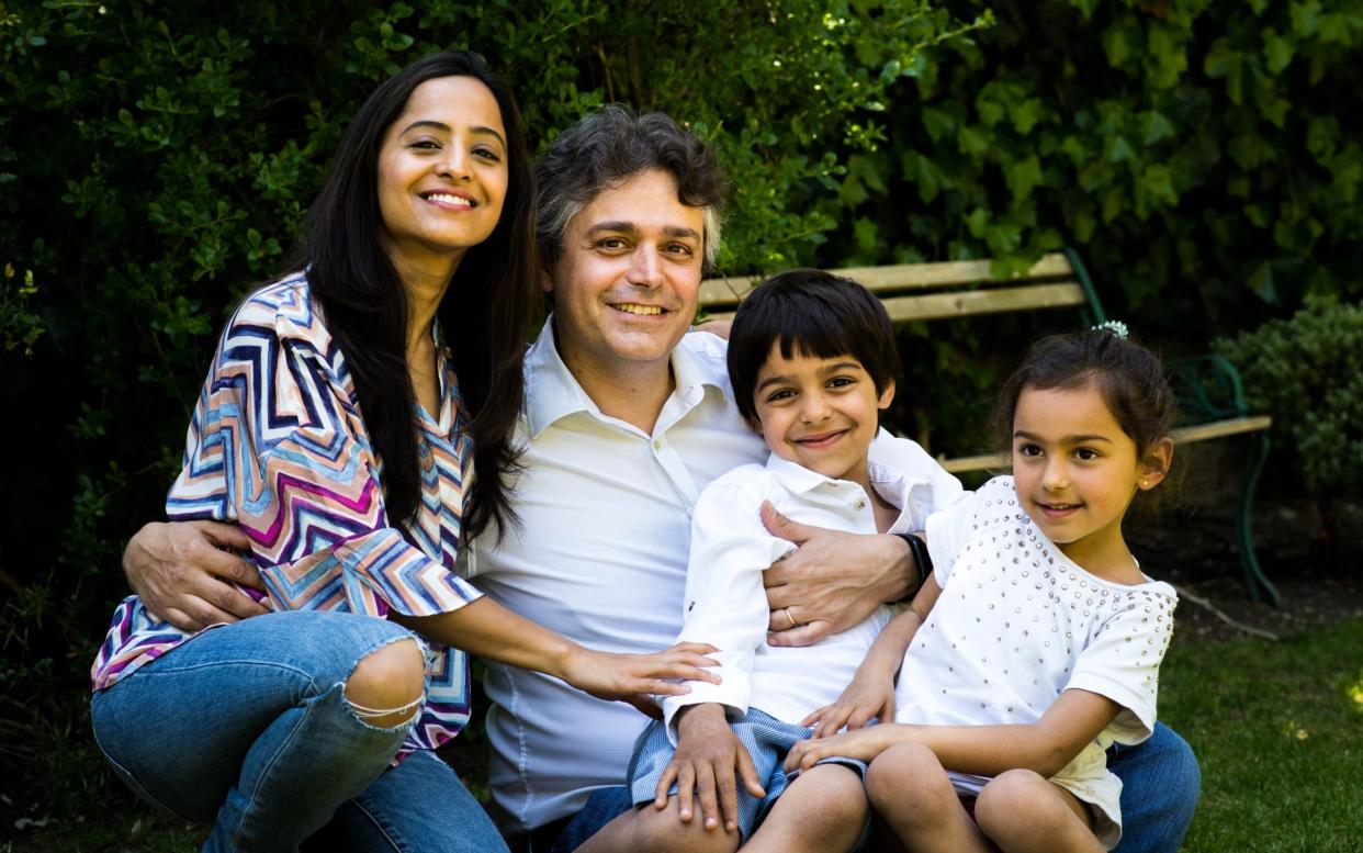 Recovered: Dr Alessandro Giardini, pictured at at home with his wife, Priyanka, and their children - NHSBT/Fleeting Moments Photography