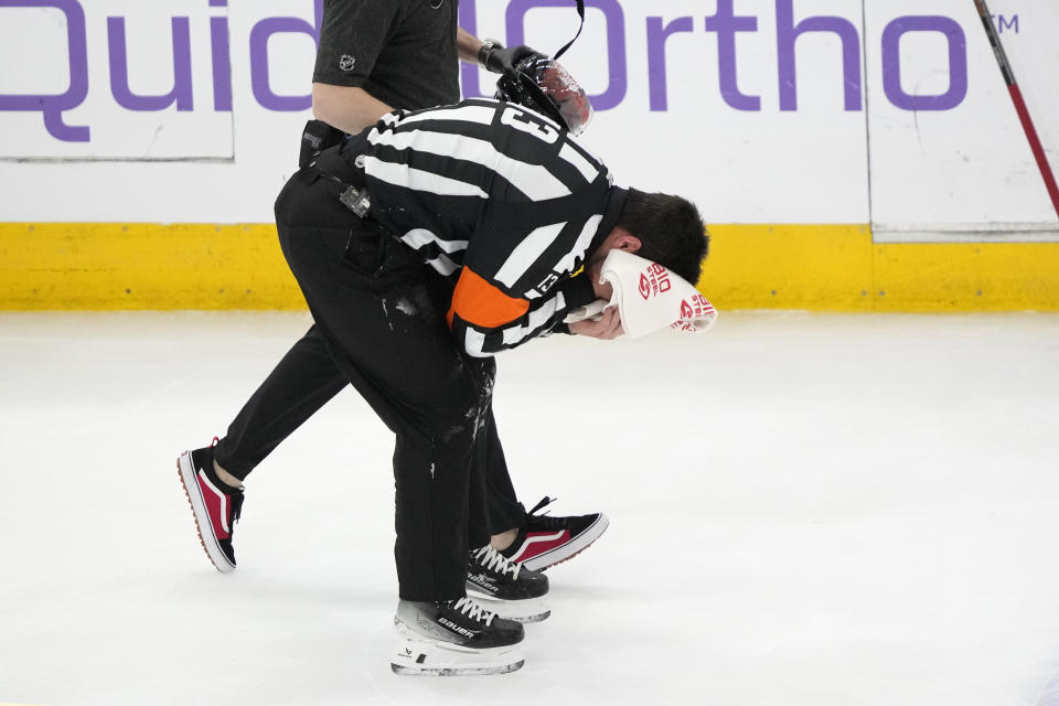 Referee Furman South skates off the ice after being in the head area during the first period of an NHL hockey game between the Chicago Blackhawks and the Ottawa Senators Saturday, Feb. 17, 2024, in Chicago. (AP Photo/Charles Rex Arbogast)
