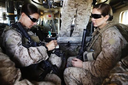 U.S. Marine and Female Engagement Team leader Sgt. Sheena Adams (L) and H.N. Shannon Crowley from First Battalion, Eighth Marines sit in an armoured vehicle before heading out on an operation from their base at Musa Qala in southern Afghanistan's Helmand province November 13, 2010. REUTERS/Finbarr O'Reilly