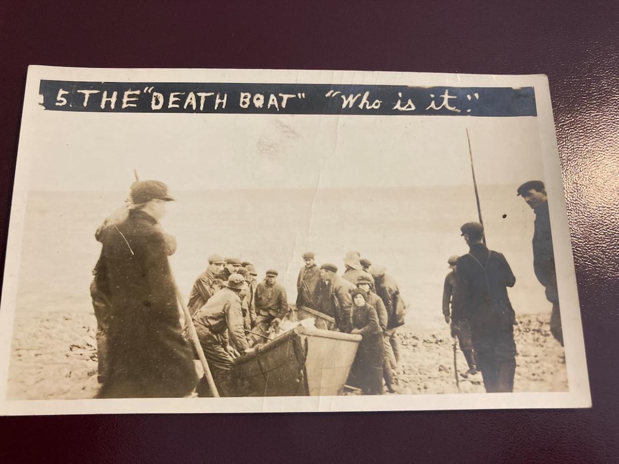 The 'Death Boat; postcard depicts the bodies of people who drowned after the sinking of the SS Florizel in 1918 off southern Newfoundland. (Mariam Mesbah/CBC - image credit)