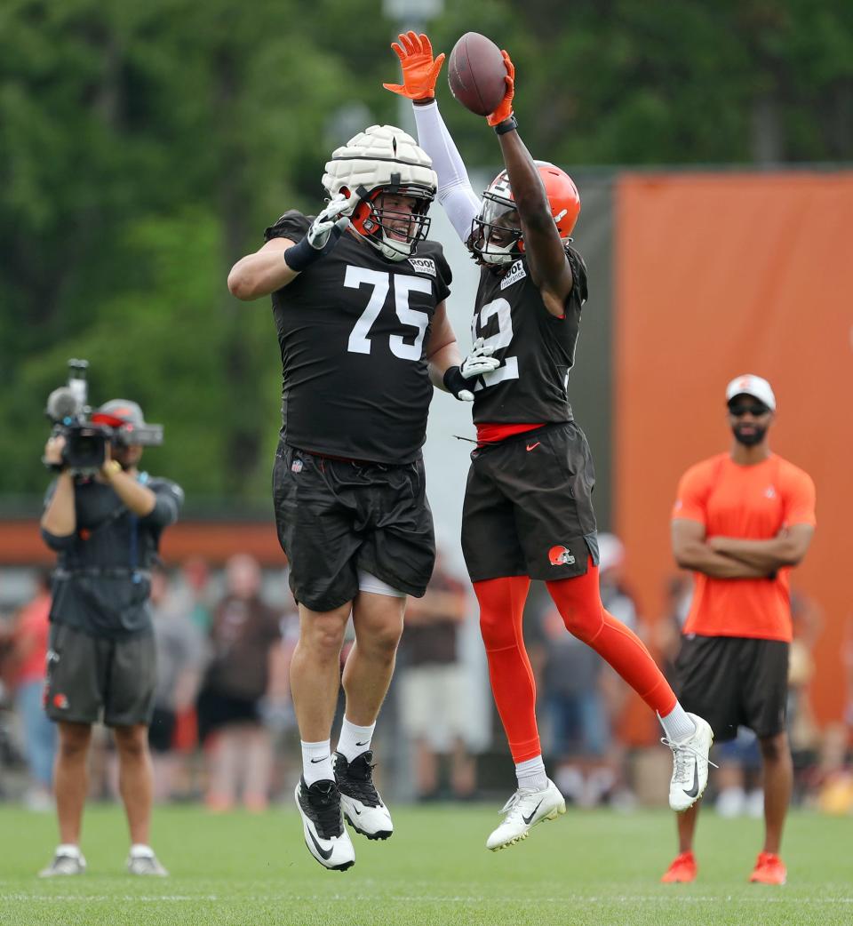 Cleveland Browns guard Joel Bitonio, left, celebrates a TD catch with receiver Michael Woods II during the team's 2022 training camp in Berea.