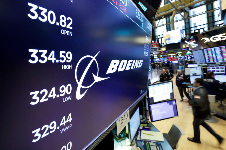 FILE- In this April 6, 2018, file photo the logo for Boeing appears above the post where it trades on the floor of the New York Stock Exchange. Boeing Co. reports earnings Wednesday, Oct. 24. (AP Photo/Richard Drew, File)