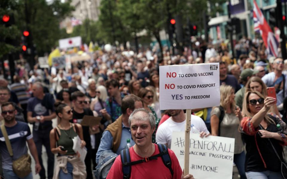 Many protesters held placards railing against their freedoms being curtailed - Aaron Chown/PA Wire