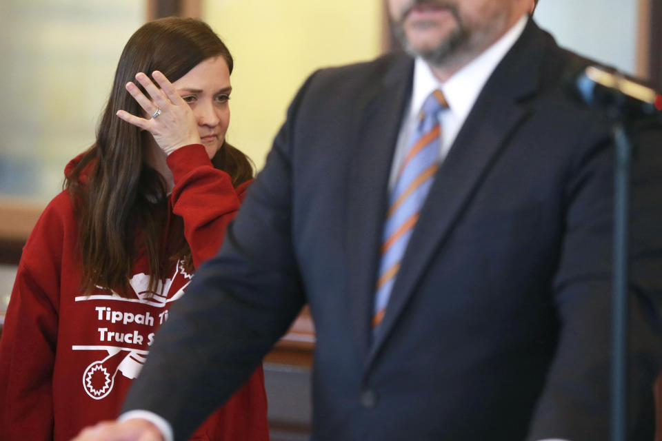 Amber Miskelly, daughter of Felicia Cox, who has been missing since July 2007, wipes tears from her face as District Attorney John Weddle, right, holds a press conference Monday, Dec. 6, 2021, in the Pontotoc County Courthouse, in Pontotoc, Miss., regarding information provided to his office by the attorneys of recently executed inmate David Neal Cox. Before his execution on Nov. 17, Cox told his attorneys he killed his sister-in-law Felicia Cox in 2007 and provided detailed instructions on where investigators could find her remains, said Weddle. (Adam Robison/The Northeast Mississippi Daily Journal via AP)