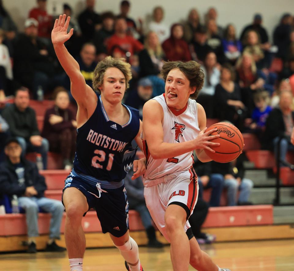 Field senior Jimmy Cultrona drives downcourt with Rootstown junior Branden Bobbs on defense during Tuesday night’s game at Field High School. Field defeated Rootstown 61-50.