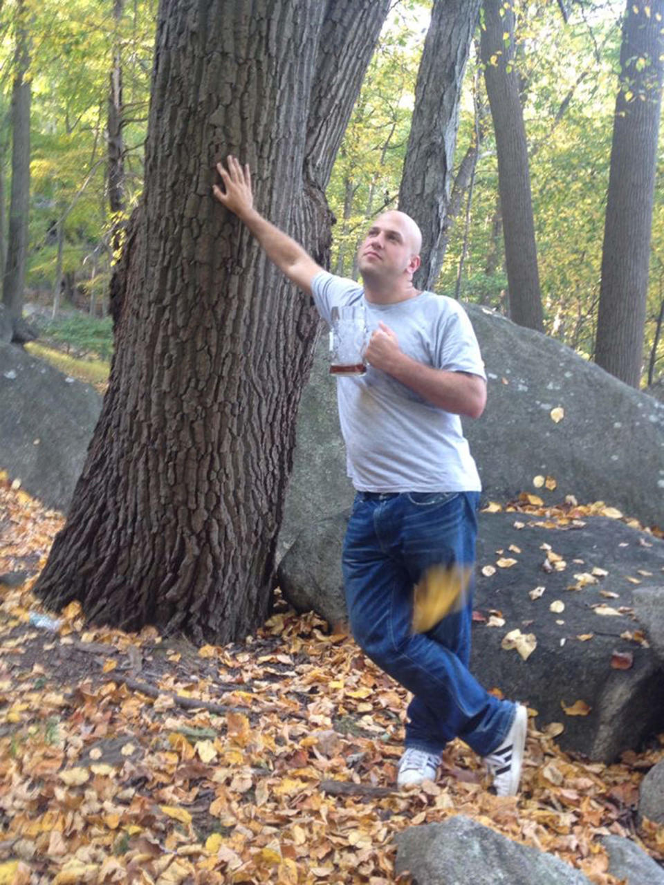 photo of yosef leaning agains a tree drinking a beer. This image was taken before he got into running  (Courtesy Yosef Herzog)