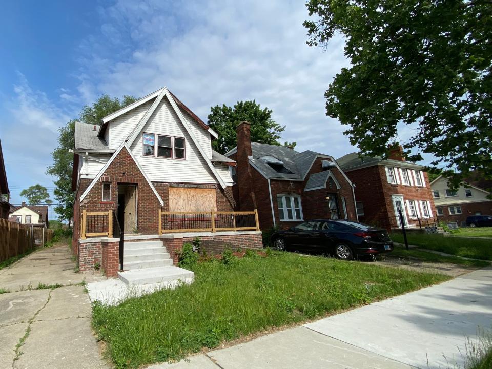 An abandoned home with a renovated deck at detroit land bank authority.