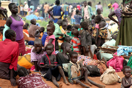 FILE PHOTO: South Sudanese refugees gather with their belongings after crossing into Uganda at the Ngomoromo border post in Lamwo district, northern Uganda, April 4, 2017. REUTERS/Stringer/File photo