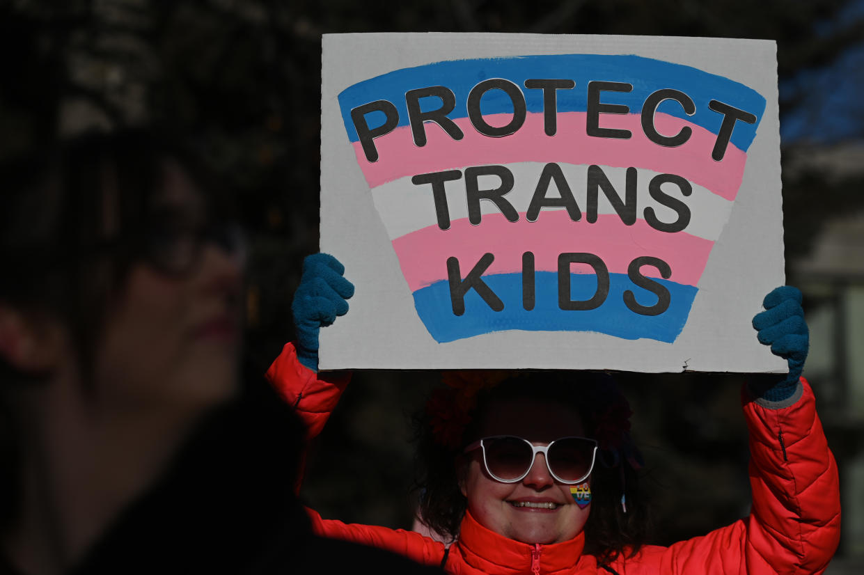 EDMONTON, CANADA - FEBRUARY 03, 2024:
An activist holds a poster as hundreds of activists, allies, and members of the transgender community gather at Dr. Wilbert McIntyre Park in Old Strathcona, protesting Premier Danielle Smith's proposed LGBTQ2S+ legislation and opposing legislation affecting transgender and non-binary youth, on February 03, 2024, in Edmonton, Alberta, Canada.
Protests ignited after Premier Smith's recent announcement to restrict vital procedures for transgender youth, sparked by a social media video mandating parental notification and consent. (Photo by Artur Widak/NurPhoto via Getty Images)