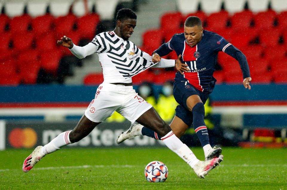 Axel Tuanzebe shields the ball from Kylian Mbappe (EPA)