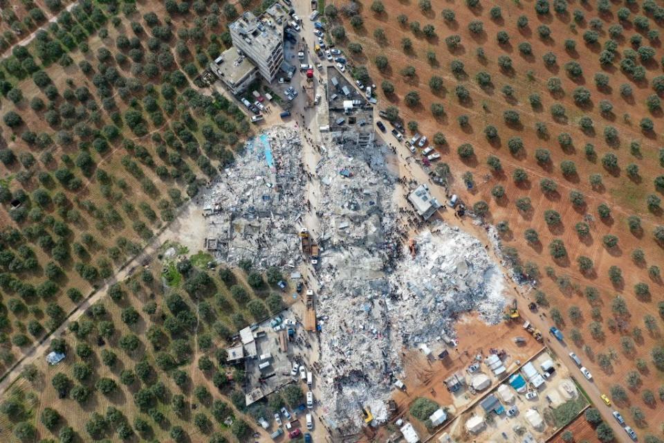 topshot this aerial view shows residents searching for victims and survivors amidst the rubble of collapsed buildings following an earthquake in the village of besnia near the twon of harim, in syrias rebel held noryhwestern idlib province on the border with turkey, on february 6, 2022 hundreds have been reportedly killed in north syria after a 78 magnitude earthquake that originated in turkey and was felt across neighbouring countries photo by omar haj kadour afp photo by omar haj kadourafp via getty images