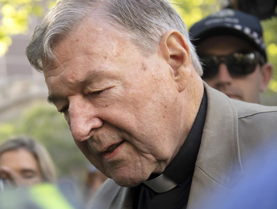 FILE - In this Feb. 27, 2019, file photo, Cardinal George Pell arrives at the County Court in Melbourne, Australia. Pell, the most senior Catholic to be convicted of child sex abuse, will be sentenced to prison Wednesday in an Australia landmark case that has polarized observers. High-profile Australian journalists face possible prison sentences, and large media organizations could face fines after being ordered to appear in court next month for allegedly breaching a gag order on reporting about Pell's convictions on charges of sexually molesting two choirboys. (AP Photo/Andy Brownbill, File)