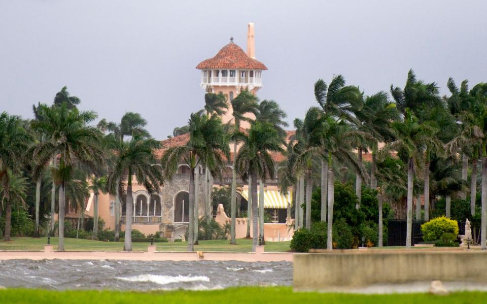 With strong winds buffeting palm trees and churning the Intracoastal Waterway, Mar-a-Lago is seen in this October 2106 photo taken when Palm Beach was threatened by Hurricane Matthew. The storm turned out largely to be no-show as it skirted the South Florida coast.