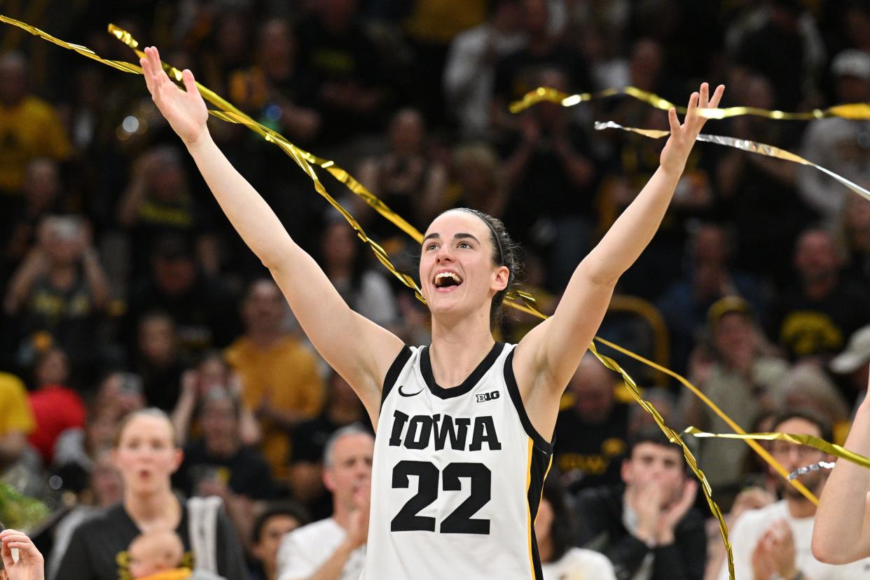 Iowa guard Caitlin Clark reacts during Sunday's Iowa-Ohio State game, which was Senior Day for the Hawkeyes. Clark broke the NCAA basketball all-time scoring record during the second quarter.