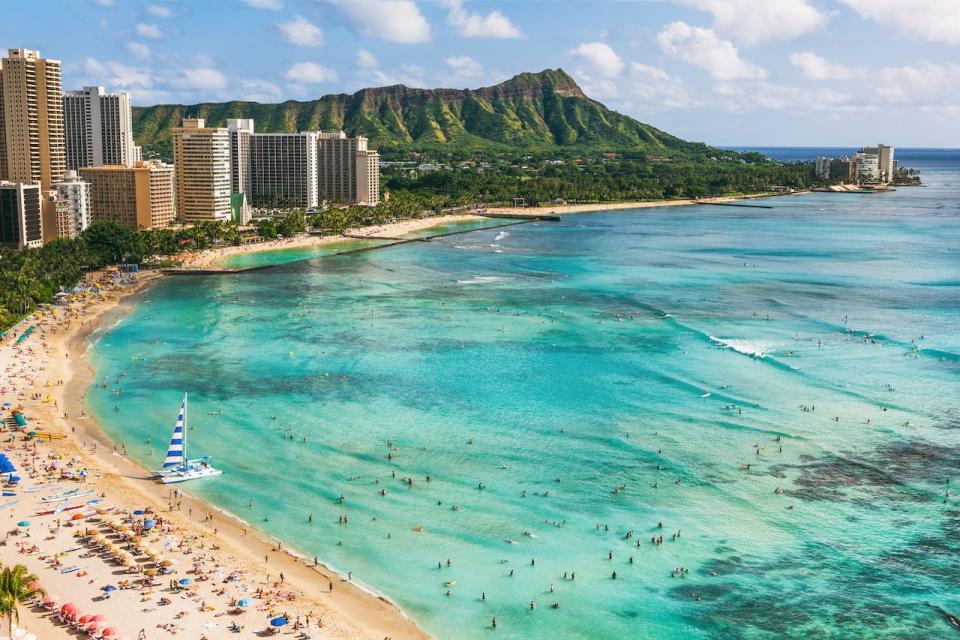 A beach with mountains in the background.