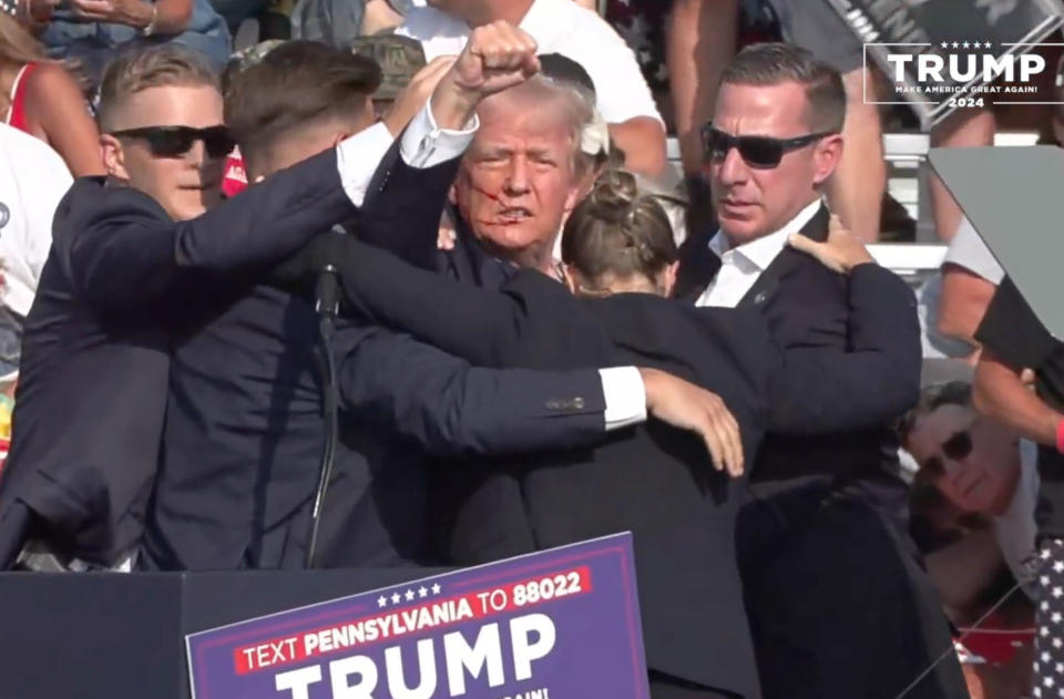 BUTLER, PENNSYLVANIA, UNITED STATES - JULY 13: (----EDITORIAL USE ONLY - MANDATORY CREDIT - 'TRUMP CAMPAIGN OFFICE / HANDOUT' - NO MARKETING NO ADVERTISING CAMPAIGNS - DISTRIBUTED AS A SERVICE TO CLIENTS----) A screen grab captured from a video shows Republican presidential candidate former President Donald Trump appears to be injured after gunshots were reported as he is rushed offstage during a rally on July 13, 2024 in Butler, Pennsylvania. Trump was seen bloodied on his right ear as he was being evacuated from the stage, according to social media footage. (Photo by Trump Campaign Office / Handout/Anadolu via Getty Images)