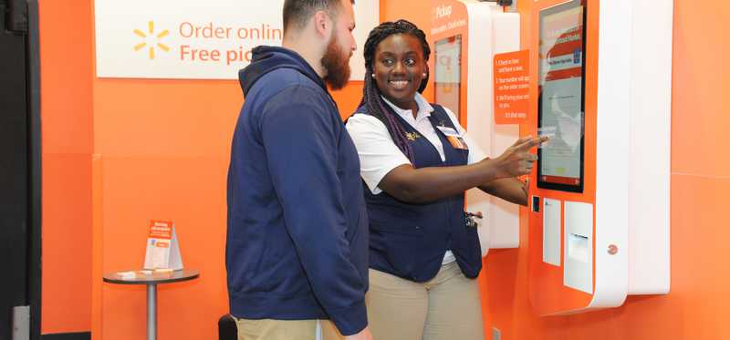 A Walmart employee helping a customer.