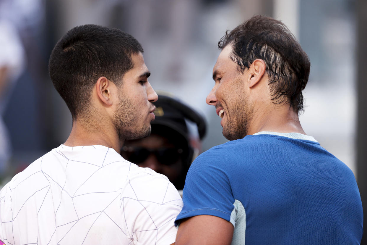 Carlos Alcaraz and Rafael Nadal talk during the Mutua Madrid Open on May 6. (David S. Bustamante/Soccrates/Getty Images)