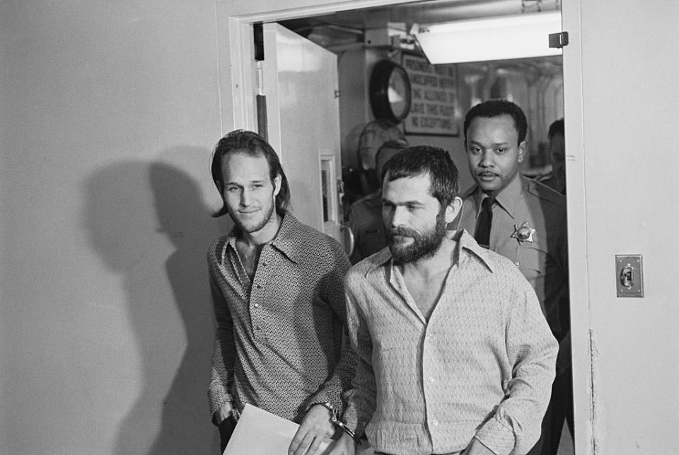 Bruce Davis (right), cuffed with fellow Manson Family member Steve Grogan. Both were convicted, along with Manson, for murdering stuntman Donald Shea. (Credit: Getty Images)