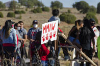 In this image provided by the Navajo Nation Office of the Speaker, family members and advocates participating in a walk on the Navajo Nation, Wednesday, May 5, 2021, near Window Rock, Ariz., to commemorate a day of awareness for the crisis of violence against Indigenous women and children. (Byron C. Shorty, Navajo Nation Office of the Speaker via AP)