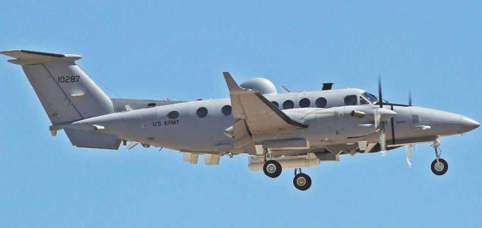 A US Army MC-12S Enhanced Medium Altitude Reconnaissance and Surveillance System-VADER (EMARSS-V) aircraft. Its podded AN/ZPY-5 radar is seen under the central fuselage. <em>Bill Word/FlickrCC</em> 