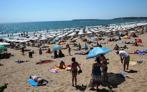 People enjoy the sun at the beach of the Black Sea resort of Sunny Beach, near the city of Bourgas - Credit: AFP/NIKOLAY DOYCHINOV