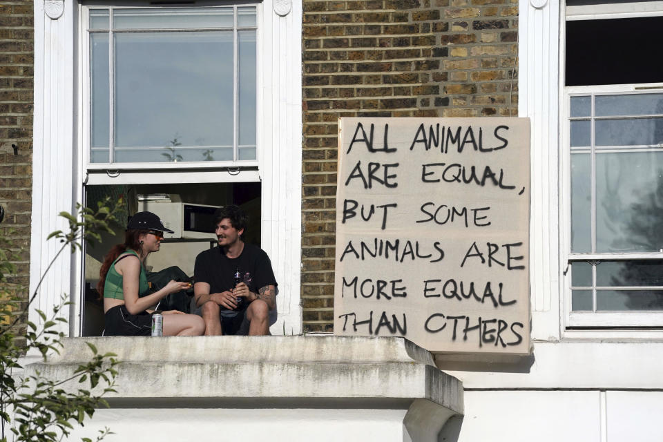 Protesters hang out a sign in the same street of where Prime Minister Boris Johnson's senior aide Dominic Cummings has his north London home after he gave a press conference over allegations he breached coronavirus lockdown restrictions, Monday May 25, 2020. (Aaron Chown/PA via AP)