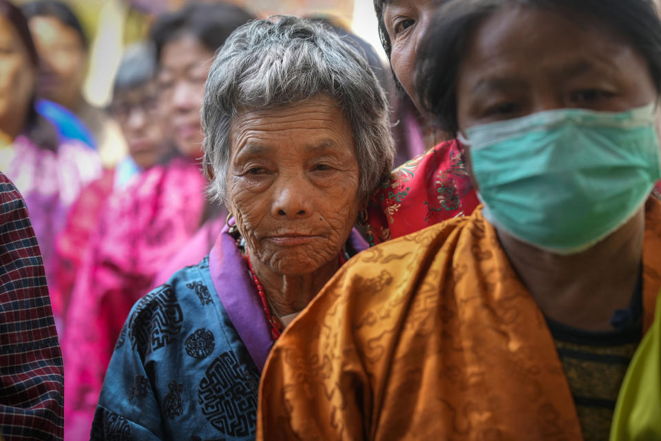 Bhutanese women stand in a queue to cast their votes at a polling centre during general election in Rikhey village, Bhutan, Tuesday, Jan. 9, 2024. Voters in Bhutan, a landlocked country in the eastern Himalayan mountain range with a population of around 800,000 people, are casting ballots to elect a new Parliament. (AP Photo/Anupam Nath)