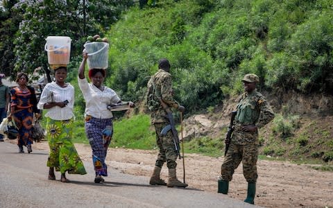 Ugandan soldiers ensuring those crossing the border do not do so without being screened for Ebola - Credit: &nbsp;Ronald Kabuubi/AP