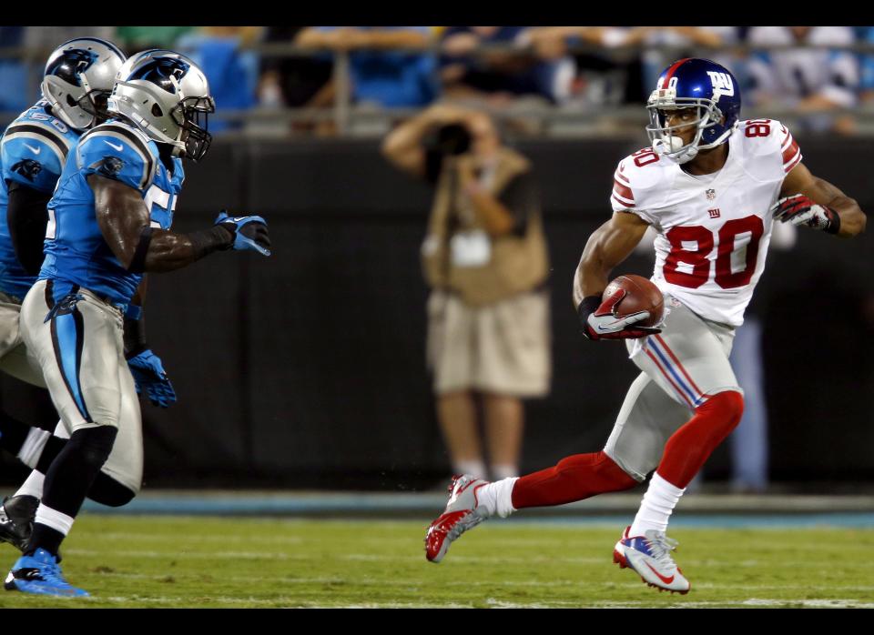 New York Giants wide receiver Victor Cruz (80) runs after a catch as Carolina Panthers linebackers Jon Beason (52) and James Anderson (50) defend during the second quarter of an NFL football game in Charlotte, N.C., Thursday, Sept. 20, 2012. 