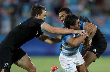 2016 Rio Olympics - Rugby - Men's Placing 5-6 - New Zealand v Argentina - Deodoro Stadium - Rio de Janeiro, Brazil - 11/08/2016. Lewis Ormond (NZL) of New Zealand and Sione Molia (NZL) of New Zealand tackle Nicolas Bruzzone (ARG) of Argentina. REUTERS/Phil Noble