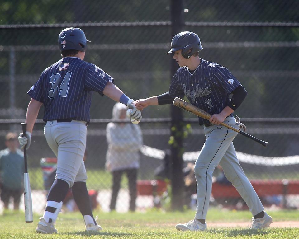 Plymouth North's Sean Petersen celebrates with Plymouth North's George Slauson after scoring a run in the top of the first inning of their game against Hingham at Hingham High on Wednesday, May 17, 2023. 