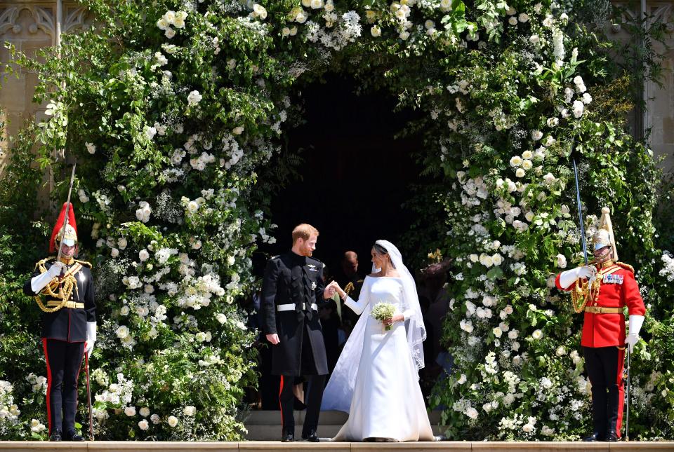 TOPSHOT - Britain's Prince Harry, Duke of Sussex and his wife Meghan, Duchess of Sussex emerge from the West Door of St George's Chapel, Windsor Castle, in Windsor, on May 19, 2018 after their wedding ceremony. (Photo by Ben STANSALL / POOL / AFP)        (Photo credit should read BEN STANSALL/AFP via Getty Images)