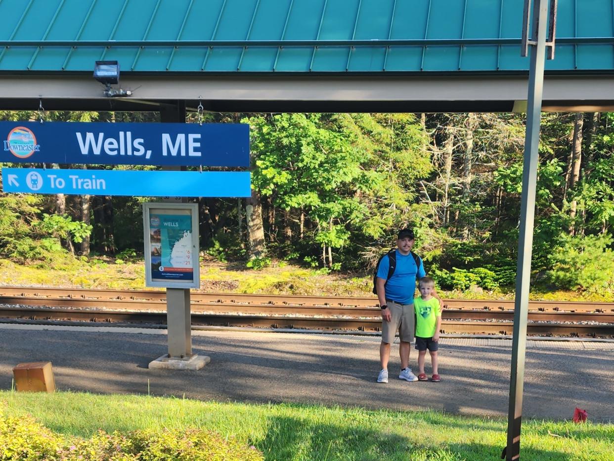 A man and child at Wells, Maine, train stop