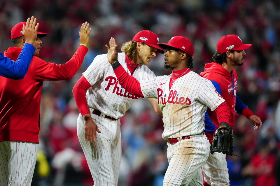 PHILADELPHIA, PA - OCTOBER 21:   Jean Segura #2 of the Philadelphia Phillies high-fives teammates after winning Game 3 of the NLCS between the San Diego Padres and the Philadelphia Phillies at Citizens Bank Park on Friday, October 21, 2022 in Philadelphia, Pennsylvania. (Photo by Daniel Shirey/MLB Photos via Getty Images)