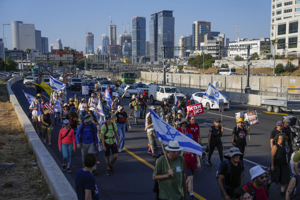 Families and friends of hostages held by Hamas in Gaza call for their return as they begin a four-day march from Tel Aviv to the Prime Minister's house in Jerusalem, in Tel Aviv, Israel, Wednesday, July 10, 2024. (AP Photo/Ohad Zwigenberg)