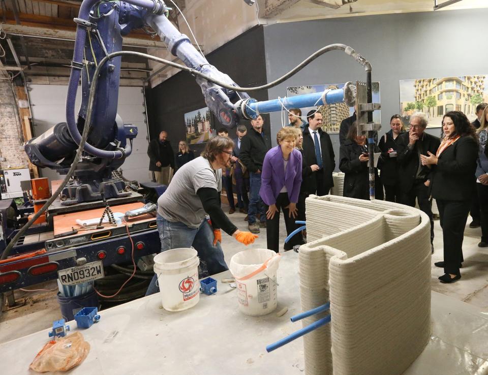 Brian Marshall helps guide the 3D printing process of concrete at MADCO3D as Sen. Jeanne Shaheen, D-New Hampshire and Isabel Casillas Guzman, administrator of the Small Business Administration observe Friday, Dec. 8, 2023 in Rochester.