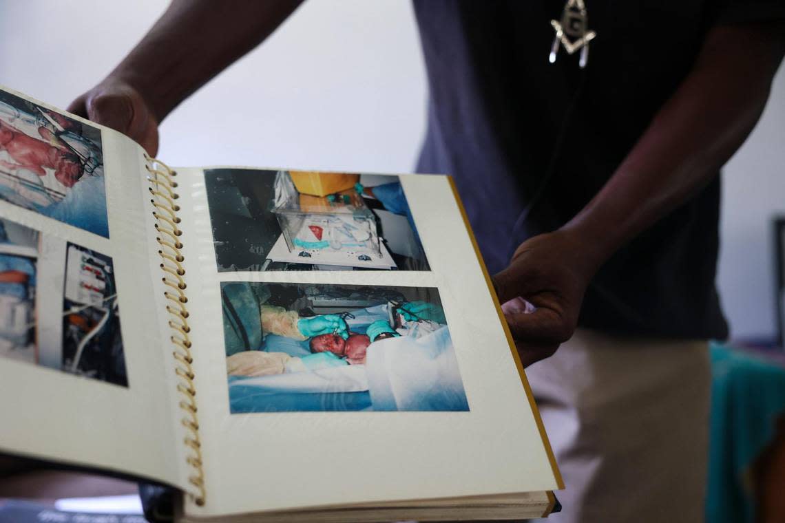 Leo Grant Jr., a South Bay resident charged with voter fraud, flips through his photo album, filled with pictures of his children, a boy who is 6 and twin boys who are 14.