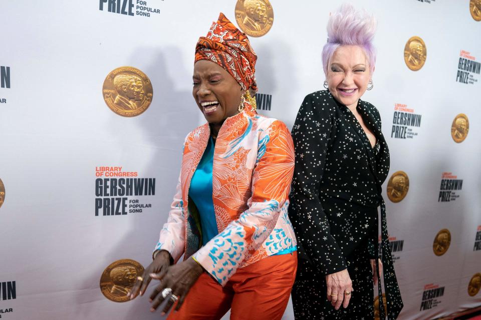 Beninese singer-songwriter Angelique Kidjo (L) and singer Cyndi Lauper arrive for the Library of Congress Gershwin Prize for Popular Song ceremony in Washington, D.C., March 1, 2023.