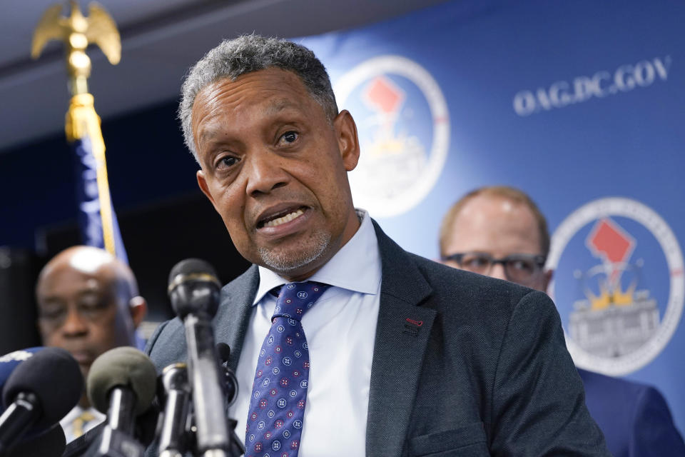 FILE - District of Columbia Attorney General Karl Racine speaks during a news conference in Washington, Nov. 10, 2022. Racine says his office is filing a civil consumer protection lawsuit against the Washington Commanders, owner Dan Snyder, the NFL and Commissioner Roger Goodell. According to a report published Thursday, Dec. 8, by the U.S. House Committee on Oversight and Reform, the Washington Commanders created a “toxic work culture” for more than two decades, “ignoring and downplaying sexual misconduct” by men at the top levels of the organization. (AP Photo/Susan Walsh, File)