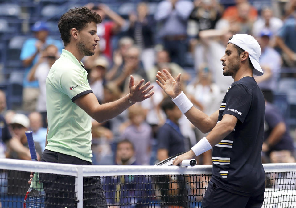 Dominic Thiem, of Austria, left, congratulates Thomas Fabbiano, of Italy, after Fabbiano won their first-round match of the US Open tennis tournament Tuesday, Aug. 27, 2019, in New York. (AP Photo/Michael Owens)