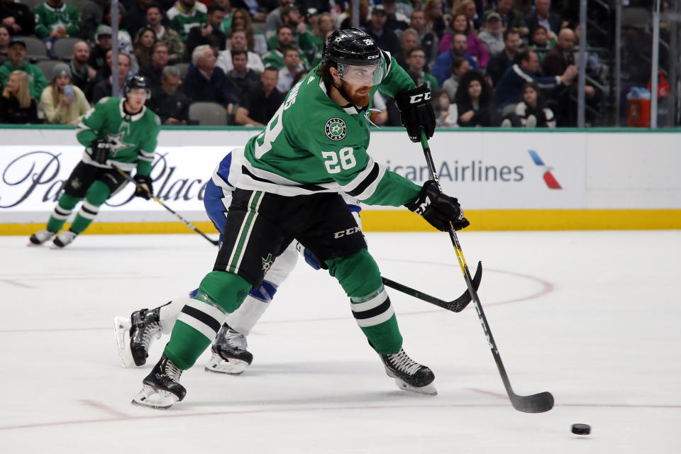 Dallas Stars defenseman Stephen Johns (28) clears the puck against the Tampa Bay Lightning during the second period of an NHL hockey game in Dallas, Monday, Jan. 27, 2020. (AP Photo/Ray Carlin)