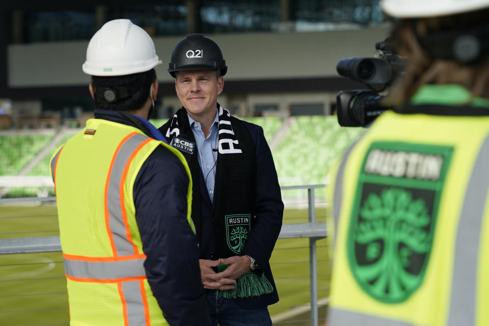 Q2 Holdings Inc. CEO Matt Flake, center, talks with the media following a ribbon cutting where the Austin FC's new stadium was named Q2 Stadium, Monday, Jan. 25, 2021, in Austin, Texas. (AP Photo/Eric Gay)