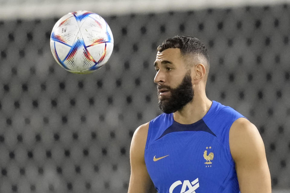 France's Karim Benzema eyes the ball during a training session at the Jassim Bin Hamad stadium in Doha, Qatar, Saturday, Nov. 19, 2022. France will play their first match in the World Cup against Australia on Nov. 22. (AP Photo/Christophe Ena)