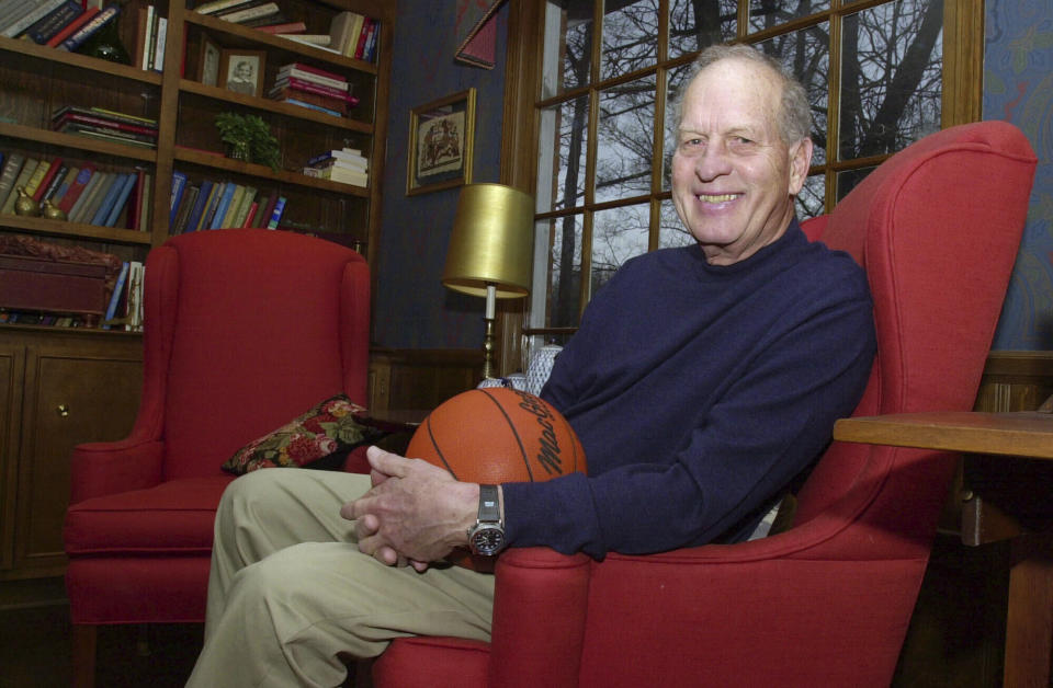 FILE - Frank Selvy poses with a basketball that belongs to his son, Mike, at his home Thursday, Feb. 5, 2004, in Simpsonville, S.C. Furman's Frank Selvy holds the NCAA record by scoring 100 points against Newberry on Feb. 13, 1954. According to Furman, Selvy sent 41 for 66 from the field, made 18 of 22 free throws and had 13 rebounds. (AP Photo/Mary Ann Chastain, File)