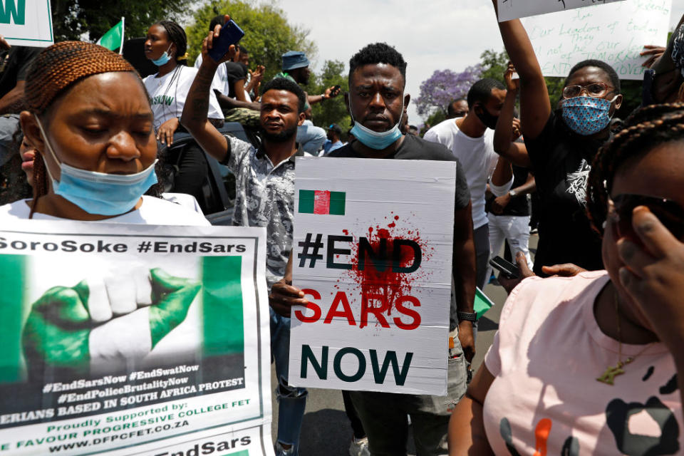 A Nigerian man based in South Africa holds a poster reading "#EndSARSNow" during a protest outside their embassy in Pretoria on Oct. 21, 2020 in solidarity with Nigerian youth.<span class="copyright">Phill Magakoe—AFP/Getty Images</span>