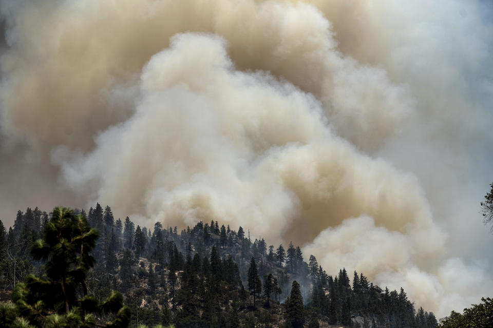 Smoke rises from the Dixie Fire burning along Highway 70 in Plumas National Forest, California, on July 16, 2021. / Credit: Noah Berger/AP